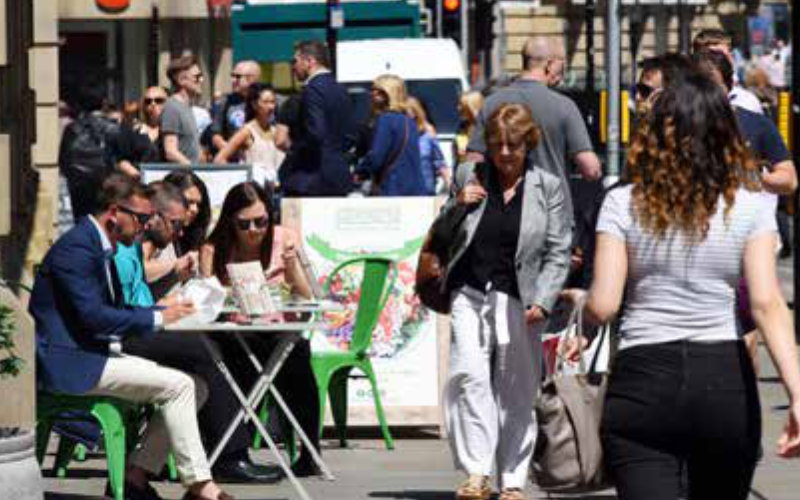 Manchester street scene with people eating out